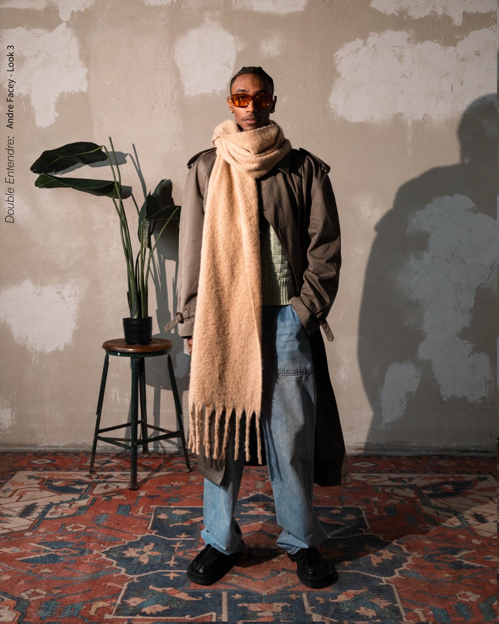 Dre in an oversized camel scarf and trench with orange lenses, Look 3 of the Double Entendre lookbook